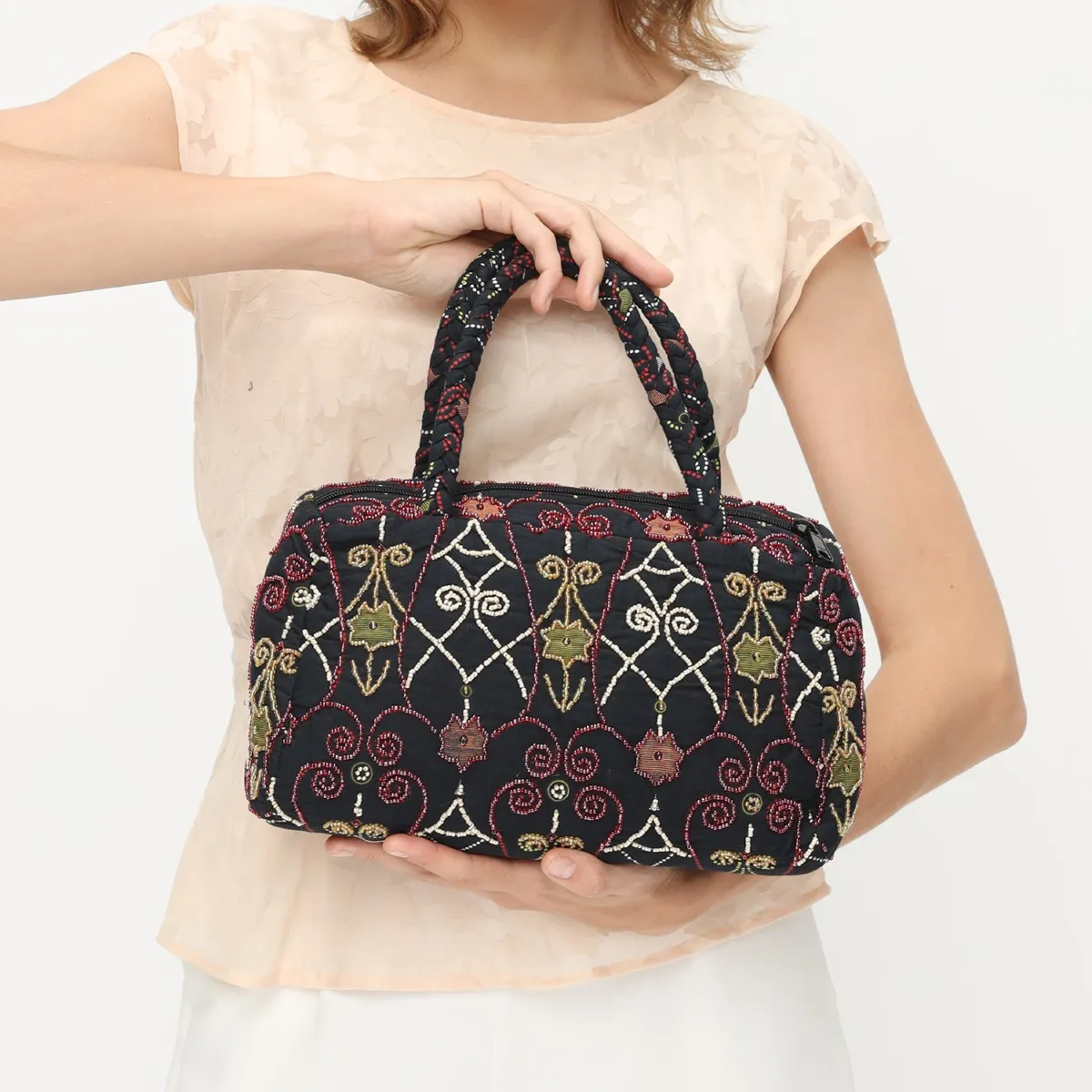 Batik Royal Charm handbag with a lattice-inspired batik motif and beadwork